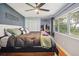 Relaxing main bedroom with large windows, a cozy bed, and ample natural light at 1212 Lake Point Dr, Lakeland, FL 33813