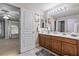 Double vanity bathroom with modern wood cabinets and a large mirror at 1872 Eloise Cove Dr, Winter Haven, FL 33884