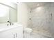 Elegant bathroom with white fixtures and marble shower at 3225 Parkwood Ct, Kissimmee, FL 34744