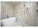 Elegant bathroom with soaking tub and walk-in shower, featuring marble tile at 3225 Parkwood Ct, Kissimmee, FL 34744