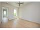 Spacious bedroom with light hardwood floors and ceiling fan at 3225 Parkwood Ct, Kissimmee, FL 34744