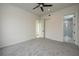 Bright and airy bedroom with grey carpet and ceiling fan at 3225 Parkwood Ct, Kissimmee, FL 34744
