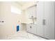 Bright laundry room with ample cabinetry and countertop space at 3225 Parkwood Ct, Kissimmee, FL 34744