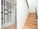 Modern staircase with light oak treads and black metal railing at 3225 Parkwood Ct, Kissimmee, FL 34744