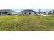 Large backyard with grassy area and view of neighboring homes at 2162 Hadley Rd, Bartow, FL 33830
