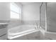 Modern bathroom featuring a corner soaking tub and marble tile at 2162 Hadley Rd, Bartow, FL 33830