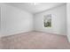 Spacious bedroom with a window and neutral colored carpet at 2162 Hadley Rd, Bartow, FL 33830