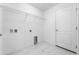 Bright laundry room features built-in shelving and modern flooring at 2162 Hadley Rd, Bartow, FL 33830
