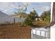 Backyard with various plants, trees, and water tank at 1051 Woodlark Dr, Haines City, FL 33844