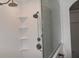 Modern bathroom with white wave tile and glass shower door at 1051 Woodlark Dr, Haines City, FL 33844