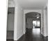 Bright entryway with dark hardwood floors and arched doorways at 1051 Woodlark Dr, Haines City, FL 33844