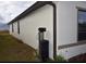 Side of house with water filtration system at 1051 Woodlark Dr, Haines City, FL 33844