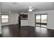 Living room featuring dark hardwood floors and sliding glass doors at 1051 Woodlark Dr, Haines City, FL 33844
