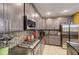 Modern kitchen with gray cabinets, granite countertops and tile backsplash at 1041 Bradford Ridge Dr, Leesburg, FL 34748