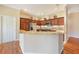 Modern kitchen with granite countertops and wood cabinets at 1049 Carver Ct, The Villages, FL 32163