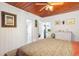 Serene bedroom with white walls, ceiling fan, and access to another room at 13081 E Highway 25, Ocklawaha, FL 32179