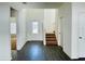 Bright entryway with wood-look floors and staircase leading to the second floor at 13446 Leaping Water Way, Astatula, FL 34705