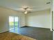 Living room with wood-look floors and sliding glass doors leading to the backyard at 13446 Leaping Water Way, Astatula, FL 34705