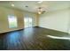 Spacious living room with dark wood flooring and sliding glass doors at 13465 Leaping Water Way, Astatula, FL 34705