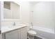 Modern bathroom with white vanity, toilet and bathtub at 13473 Leaping Water Way, Astatula, FL 34705