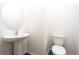 Small powder room with pedestal sink and toilet at 13477 Leaping Water Way, Astatula, FL 34705