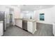 Modern kitchen with white cabinets, granite countertops and stainless steel appliances at 13477 Leaping Water Way, Astatula, FL 34705
