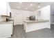 Modern kitchen with white cabinets, granite countertops and stainless steel appliances at 13477 Leaping Water Way, Astatula, FL 34705