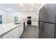 Modern kitchen with white cabinets, granite countertops and stainless steel appliances at 13477 Leaping Water Way, Astatula, FL 34705
