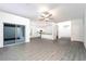 Open living area with kitchen and dining space, wood-look floors at 13477 Leaping Water Way, Astatula, FL 34705