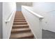 Carpeted staircase leading to the upper level at 13477 Leaping Water Way, Astatula, FL 34705