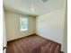 Simple bedroom with carpeted floor and a window at 13485 Leaping Water Way, Astatula, FL 34705