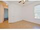 Empty bedroom with tile flooring, an open door, and a ceiling fan at 1423 Harbor Ridge Dr, Poinciana, FL 34759