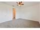 Bedroom with plush carpet, ceiling fan, and doorway leading to a walk-in closet at 1423 Harbor Ridge Dr, Poinciana, FL 34759