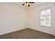 Empty bedroom with neutral carpet, white walls, and a ceiling fan at 1423 Harbor Ridge Dr, Poinciana, FL 34759