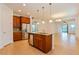 Kitchen with wood cabinetry, stainless steel appliances, and granite countertop island at 1423 Harbor Ridge Dr, Poinciana, FL 34759
