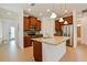 Modern kitchen with stainless steel appliances, granite countertop island, and wood cabinets at 1423 Harbor Ridge Dr, Poinciana, FL 34759