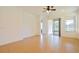 Open living area with tile flooring, ceiling fan, and sliding glass door to patio at 1423 Harbor Ridge Dr, Poinciana, FL 34759