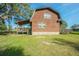 Exterior view of a charming brown barn-style house with a deck at 16 Ridge Rd, Frostproof, FL 33843