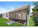 Screened-in patio with a concrete slab leads to a grassy backyard at 5638 Cedar Waxwing Dr, The Villages, FL 32163