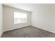Cozy bedroom with gray carpeting and a window, perfect for a guest room or office at 5638 Cedar Waxwing Dr, The Villages, FL 32163