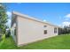 Exterior view of a home's back and side, with a screened porch and yard at 5638 Cedar Waxwing Dr, The Villages, FL 32163
