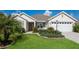 Charming single-story home with a landscaped front yard and two-car garage at 5638 Cedar Waxwing Dr, The Villages, FL 32163