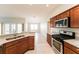 Modern kitchen featuring granite counters, stainless steel appliances, and ample cabinet space at 5638 Cedar Waxwing Dr, The Villages, FL 32163