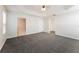Large main bedroom with plush carpeting, ceiling fan, and walk-in closet at 5638 Cedar Waxwing Dr, The Villages, FL 32163