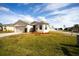 Tan house with a two-car garage and well-manicured lawn at 1046 Roberta Rd, Lake Wales, FL 33853