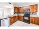 Kitchen with wood cabinets, stainless steel appliances and tile floor at 1046 Roberta Rd, Lake Wales, FL 33853