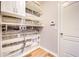 Laundry room with wood-look walls, shelving, and flooring at 1046 Roberta Rd, Lake Wales, FL 33853