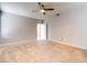 Spacious carpeted main bedroom featuring a ceiling fan and an additional door at 1046 Roberta Rd, Lake Wales, FL 33853