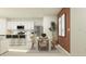 Bright dining room with white table and chairs, adjacent to kitchen at 1806 Teagan Ln, Winter Haven, FL 33884