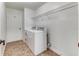 Convenient laundry room with washer, dryer, and shelving at 2804 Polson Dr, Kissimmee, FL 34758